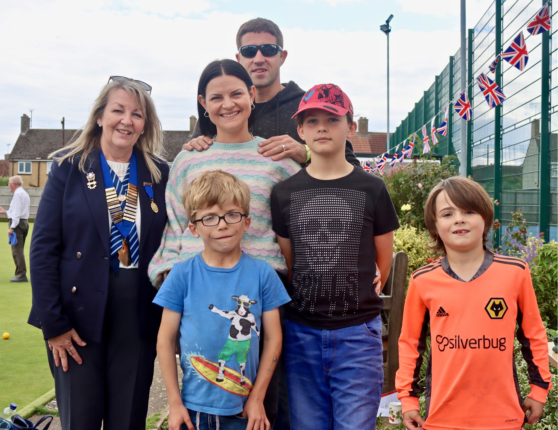 Mason Sallis (centre front) with President Rita Downs, mum Laura, dad Tony and brothers Alfie and Teddy.