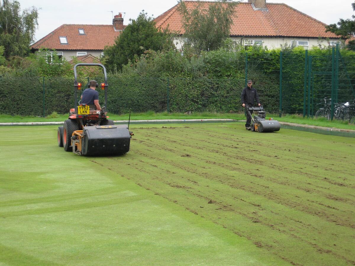 Deep scarifying and sweeping up the debris.
