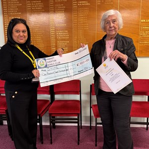 SHINE representative receiving cheque from our 2025 President Annette Oliver