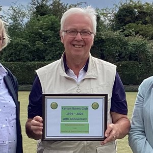 Ketton Gala: Ketton chairman Bob Warters receives a 50th anniversary plaque from Stamford Bowls League's Nina Rawlins (left) and president Rita Downs.