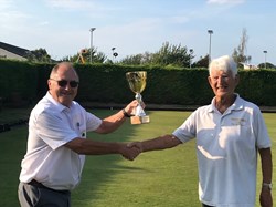 Peter McDonald (right), President, receives the trophy for the triples competition from Michael Wright, Club Chairman