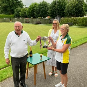 Dawn Coulter, and Adrian Zillwood receiving the Eight Financial Advice winners trophy from Mia from the clubs sponsors