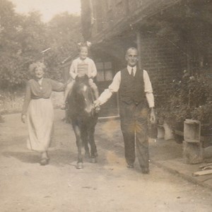 Alice Knight with Walter William Knight and Walter's daughter Pam on the horse. This would have been about 1941, on the lane from Swanworth Lane up to the stables.