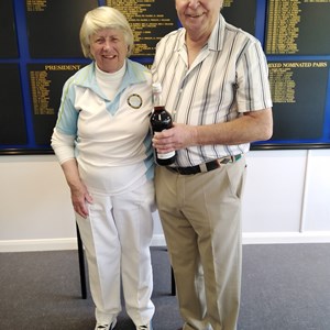 John Dall presenting the prize of a bottle of Pimms to Pat Lewis the winner of the spider