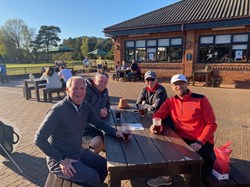 Members of the society doing what they do best, sitting down having a drink