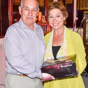 Mrs Pow presents club member Edward Broom with a set of Drakes Pride bowls which Edward won in a raffle.