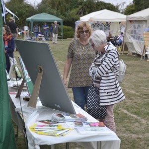 Parish Clerk talking to a resident about the display