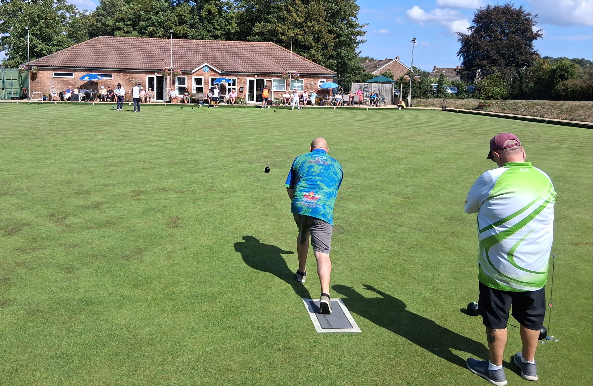 2025 Final ; Steve Taylor bowling whilst Martin Reed looks on
