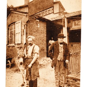 Thomas Tidy outside the forge at Byttom Hill Mickleham. August 1894