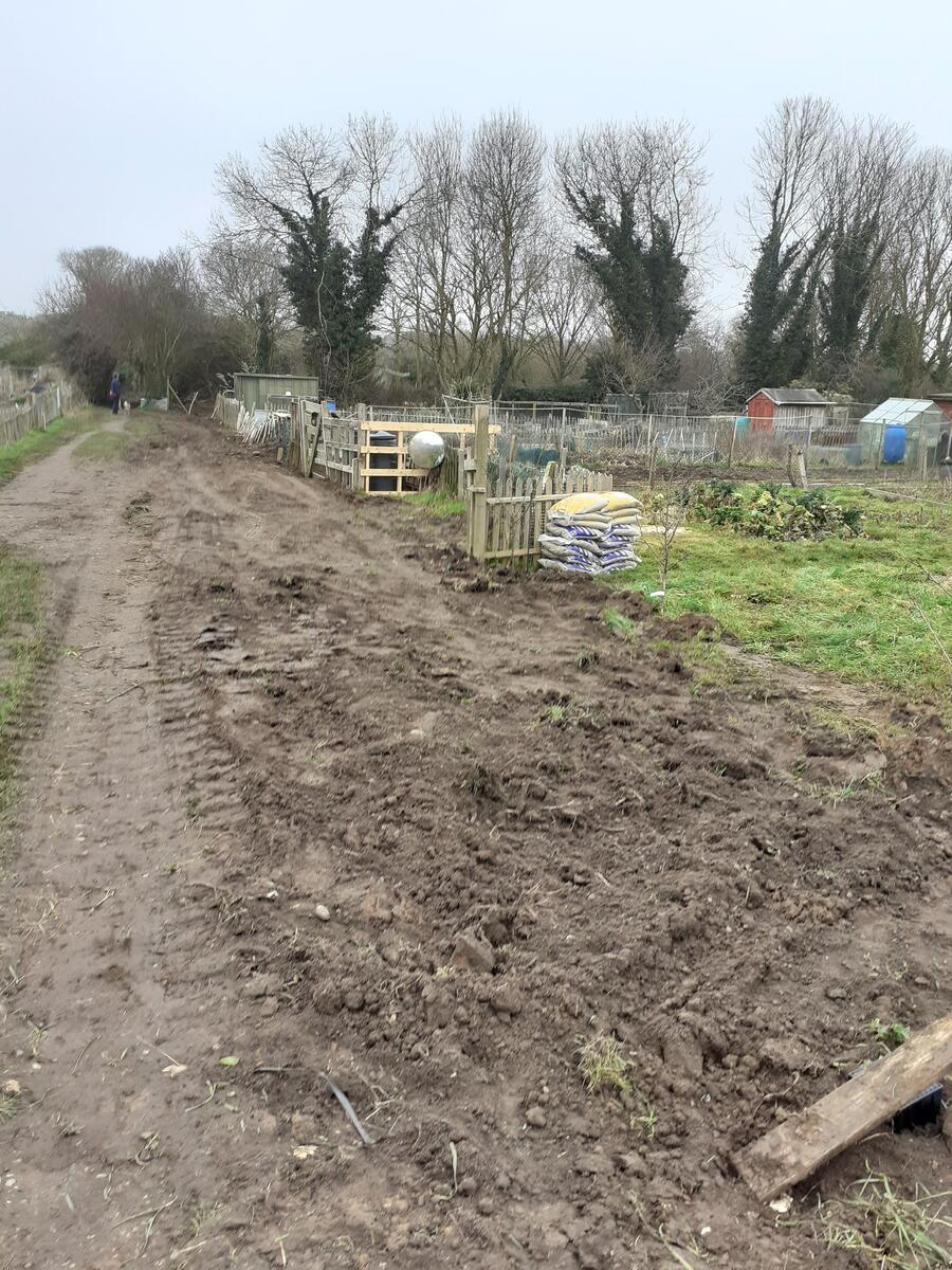 Back filling the trenches by hand