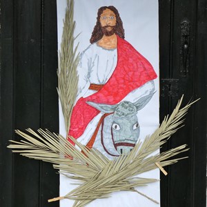 Jesus rode into Jerusalem on a donkey, greeted by crowds waving palm branches