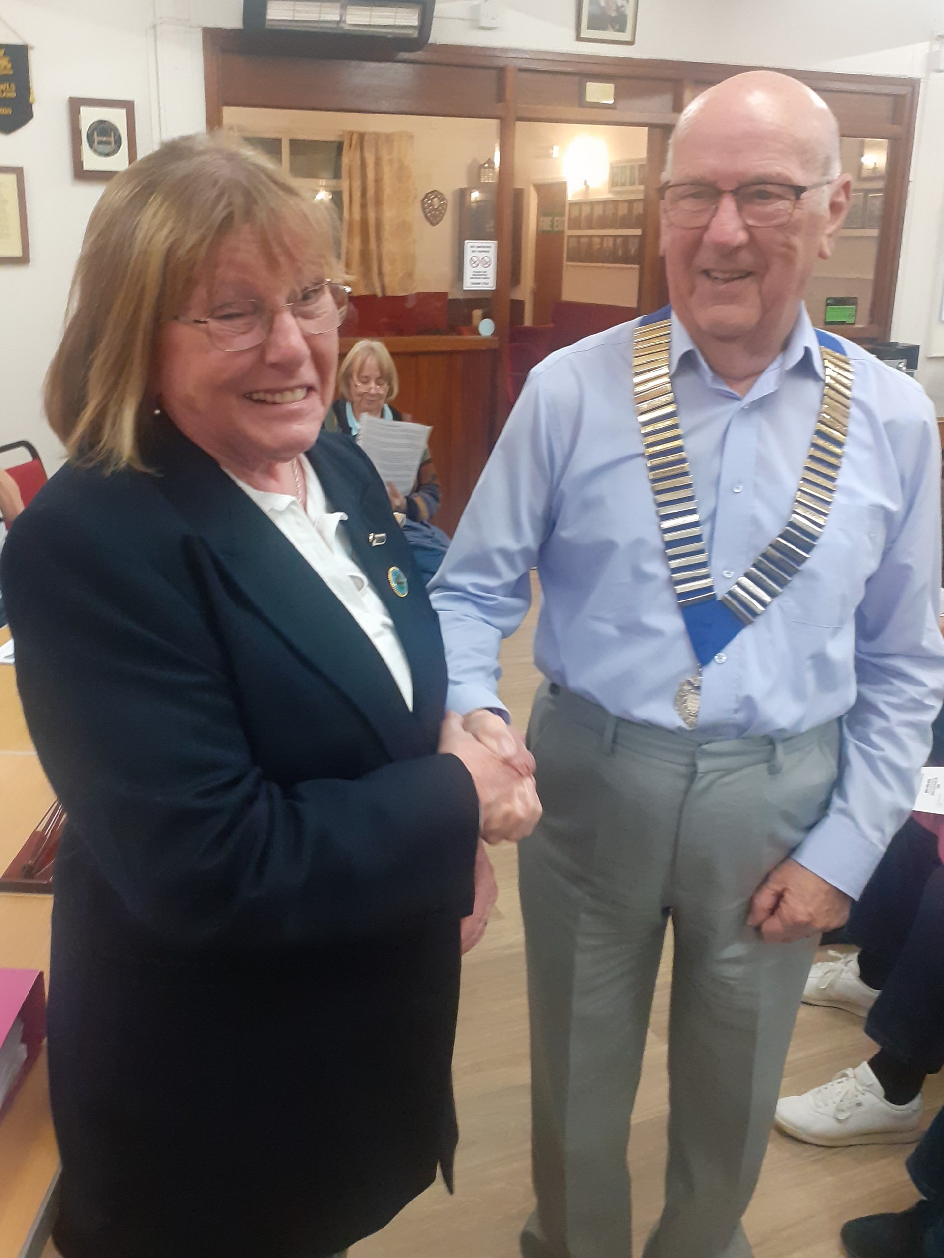 New President Dave Edwards being congratulated by outgoing President Jeannie Hutton.