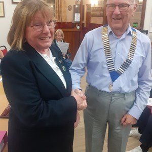 2024 President Dave Edwards receiving the chain of office from outgoing President Jeannie Hutton