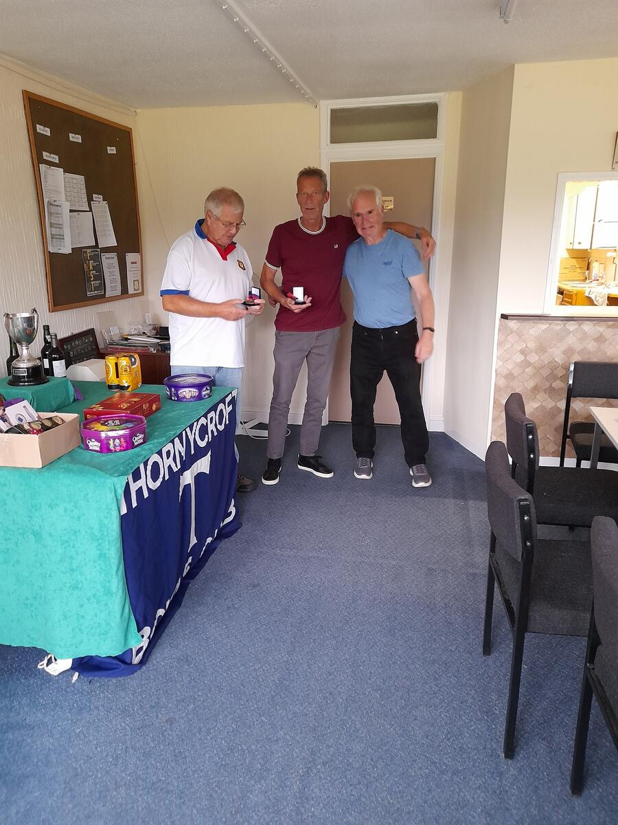 Geoff and Barry are presented with their individual medal by Dave Wright, Chairman