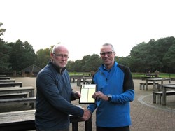 Steve, our new secretary, presents Ian with the Grand Prix trophy
