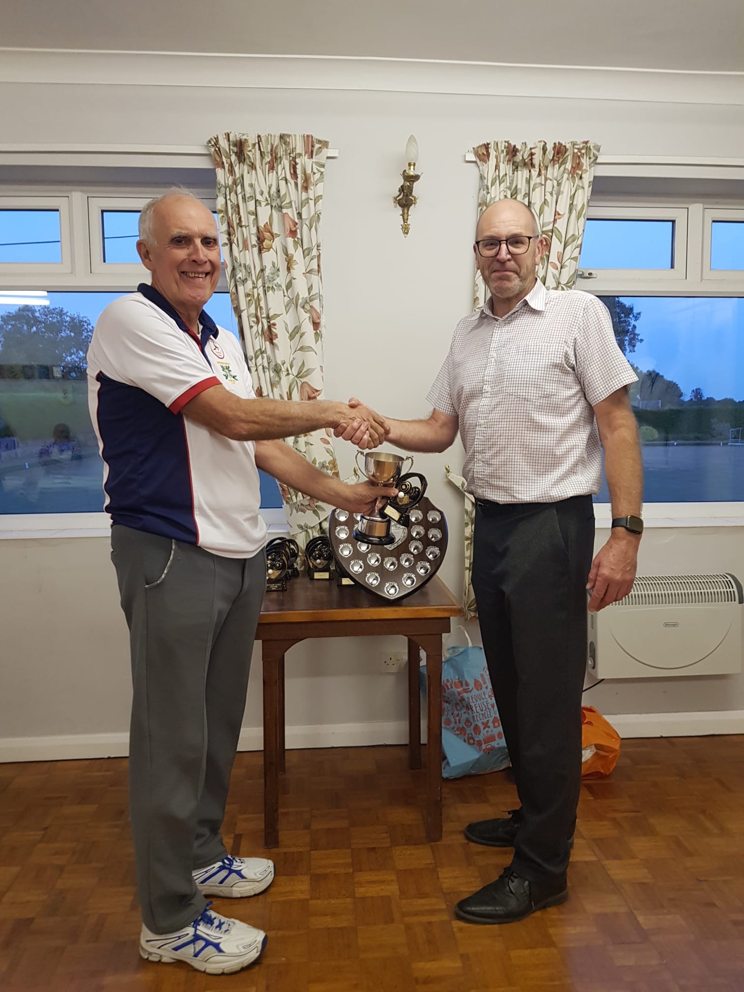 Bob Sinclair, Captain of KMS BC Batagas team, being presented with the League Winners and Fred Husband Trophy from