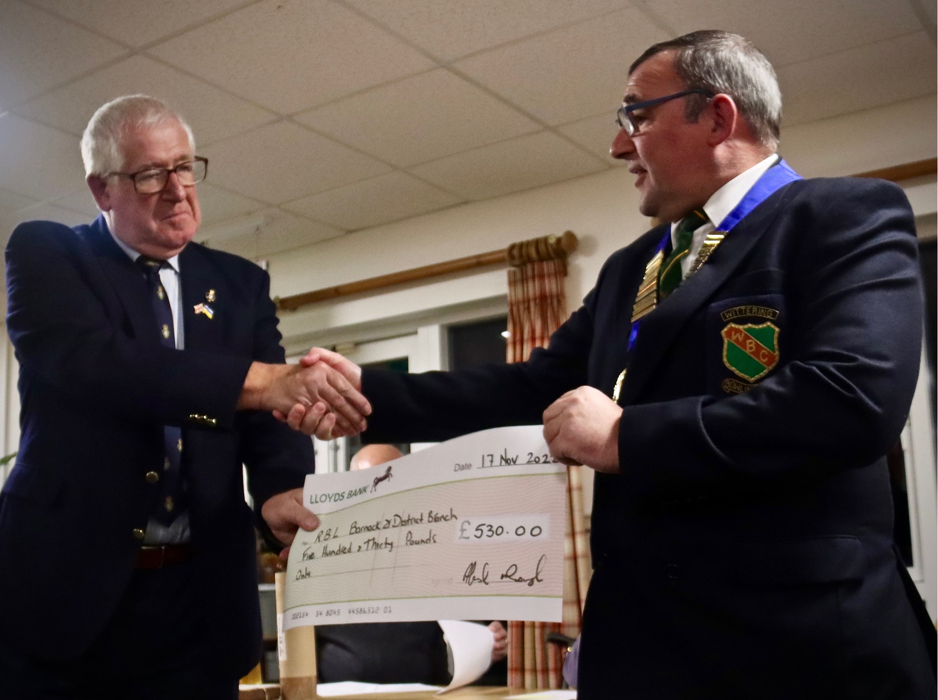President Ally McNaughton presents a cheque for £530 to Max Sawyer, President of the Royal British Legion, Barnack and District Branch