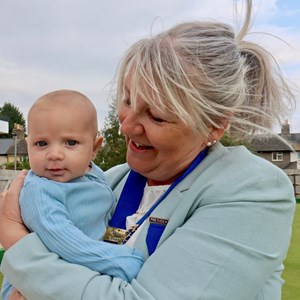 President Rita Downs with the newest member of the Bailey family.