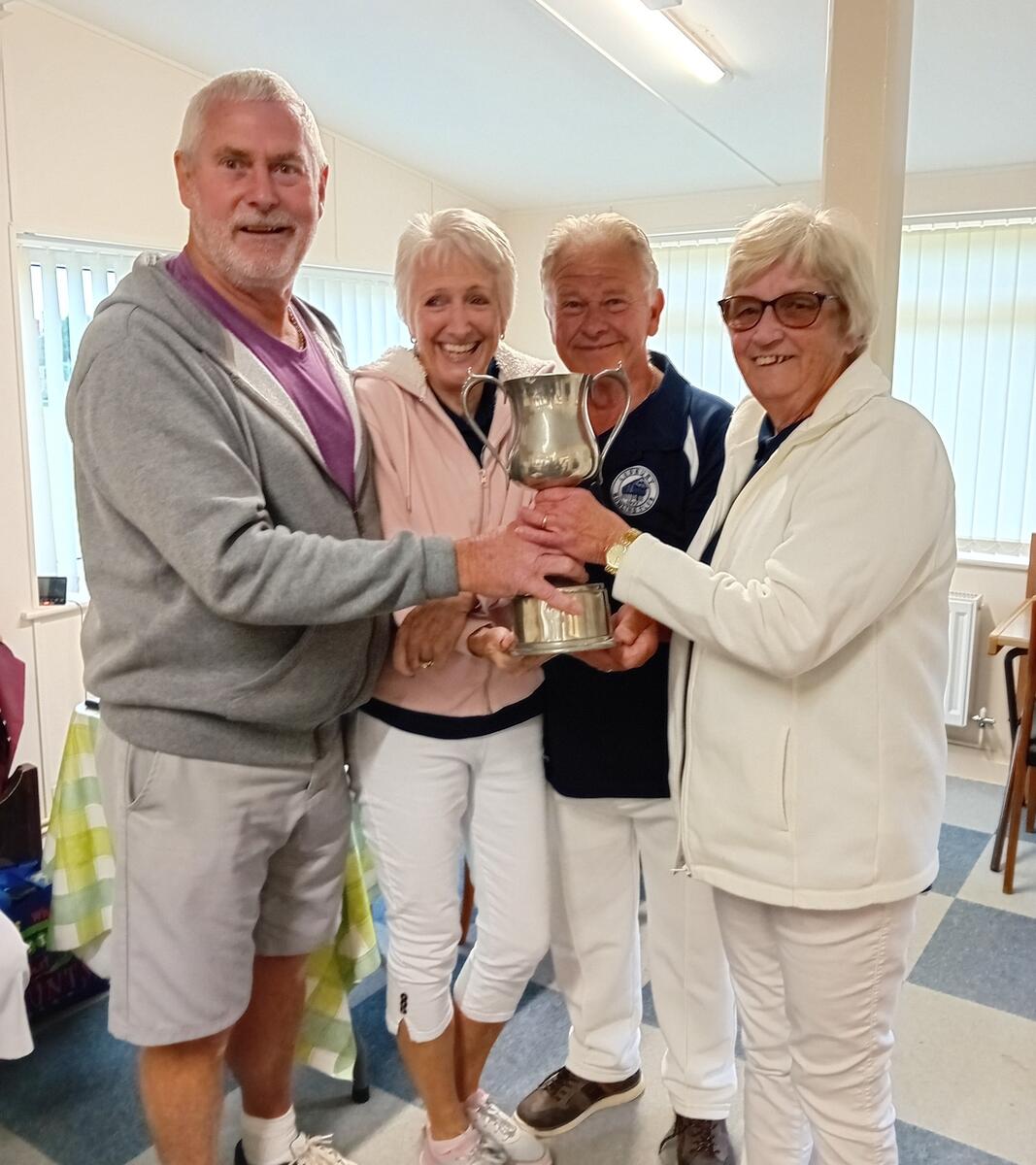 President, Terry Clarke presenting Lynda Williams, Pat Hilling and Tony Smith with their trophy