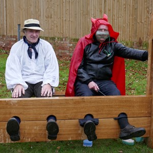 The devil and his friend in the stocks