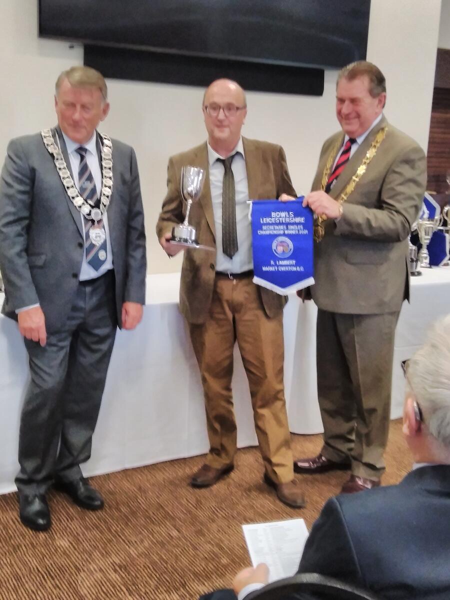 Richard Lambert receiving County Men's Secretaries Cup 2021 from Bowls Leicestershire President Terry Richards & Bowls England President Paul Robson.