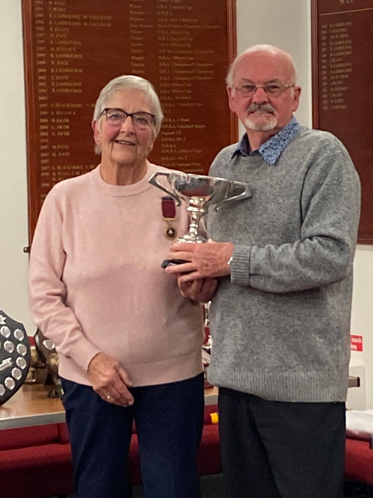 Graham Kennedy receives the trophy for the Men's Singles from President Wendy Cross