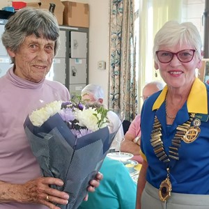 Reflex League organiser Gill May being presented with flowers