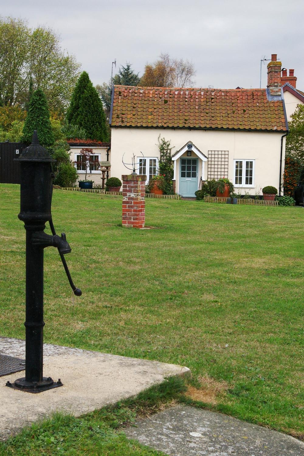 Pump and sun dial on the village green.