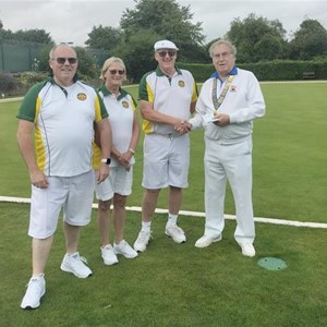 James Lapage, Dawn Coulter, and Hugh Coulter receiving the winners title in the Littleton Invitation mixed triples tournament