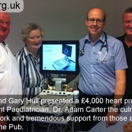 Darren and Gary Hull presenting a £4,000 heart probe to Consultant Paediatrician, Dr Adam Carter