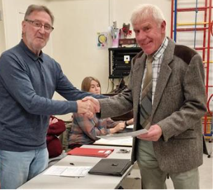 Chairman Roy Piddington awards local farmer Bob Turner the Village Champion Award for 2023.