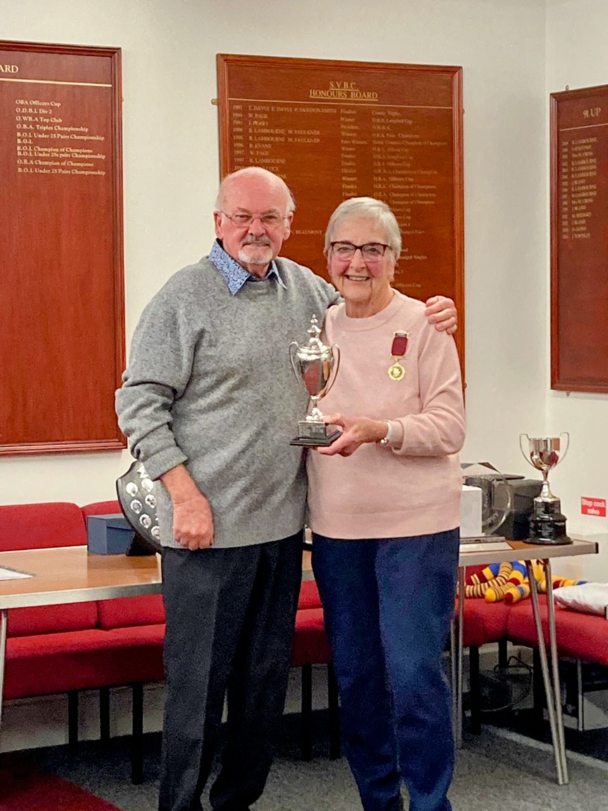 Wendy Cross is presented with the Handicap Competition Trophy by Club Chairman Graham Kennedy