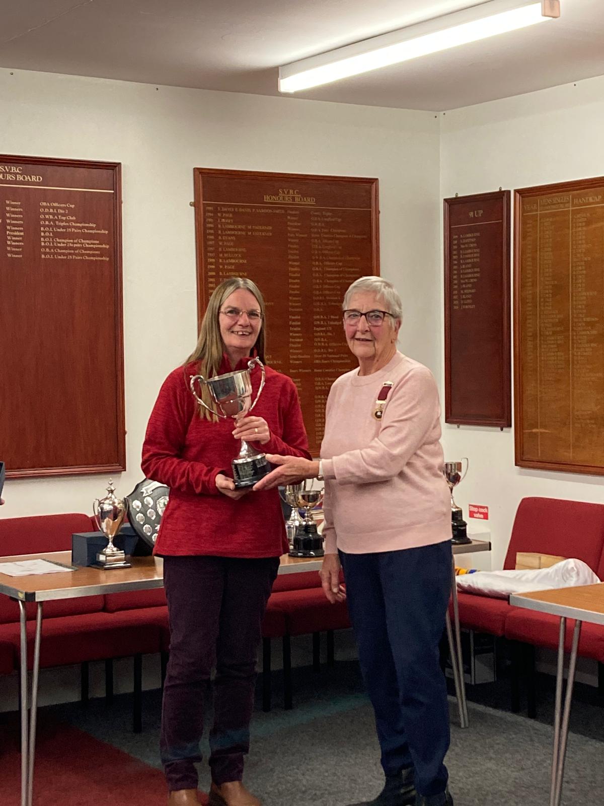 Jane Ward is presented with the trophy for the Women's Singles by Club President Wendy Cross