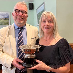 Ladies Champion - Lucy Johnson being presented with the cup by her husband Tony