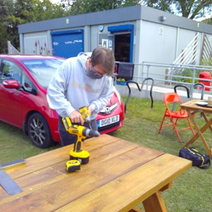 The last screw being applied to their table  by Steve at the cafe in Hull Road Park.