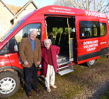 Mrs Deb Jeffs, co-founder and first Chairman of the DVG with the current chairman, alongside the all-electric HandEbus