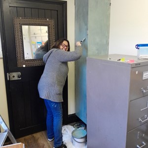 Maria re-painting Gardening Club cupboard in "Soft Sage Green"