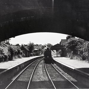 West Meon Station framed through road bridge archway.