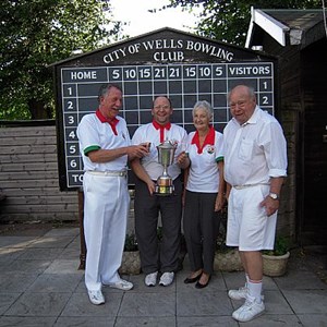 President David Bishop presenting the President's Cup to the Winners, Tony Denning, Carol Hamblin & Monty Thomas. They were the only team to win all four of their games.