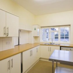 A well-equipped kitchen with serving hatch to the hall.