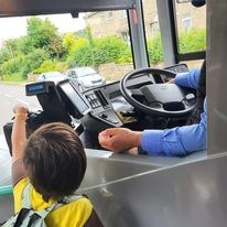 A Brownie buying her ticket from the bus driver