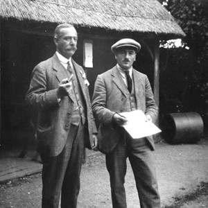 Discussing the state of the green? in front of the old thatched clubhouse, c1920