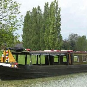 Narrowboat passes Doctor's Piece