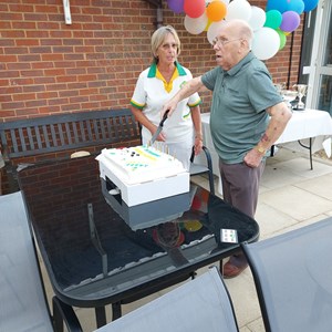 32/ Mick Wood cutting Birthday cake