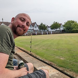 Andy enjoys a beer while watching the action (in the background)