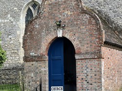 The porch, with its Flemish gable and the date 1784 over the door