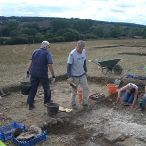 Gary stoically digging more cbm (ceramic building material) and Dave clearing away soil.
