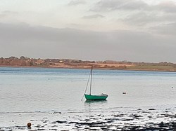 A lone boat anchored at Wrabness in Winter