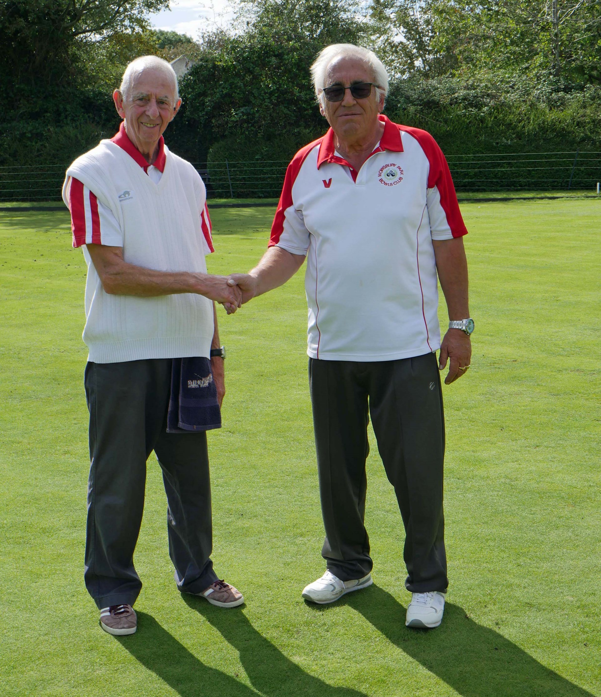Adrian (left) congratulating his opponent John on winning the Open 2 Wood Singles. The marker was Norman.