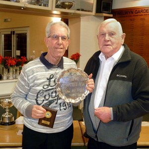 Gus Edwards, 3 woods Champion, receiving his trophy from President Fred Goodege